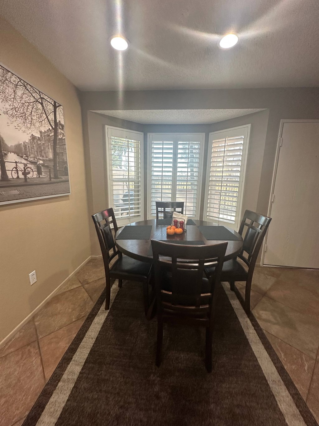 A dining room with a table set for six.