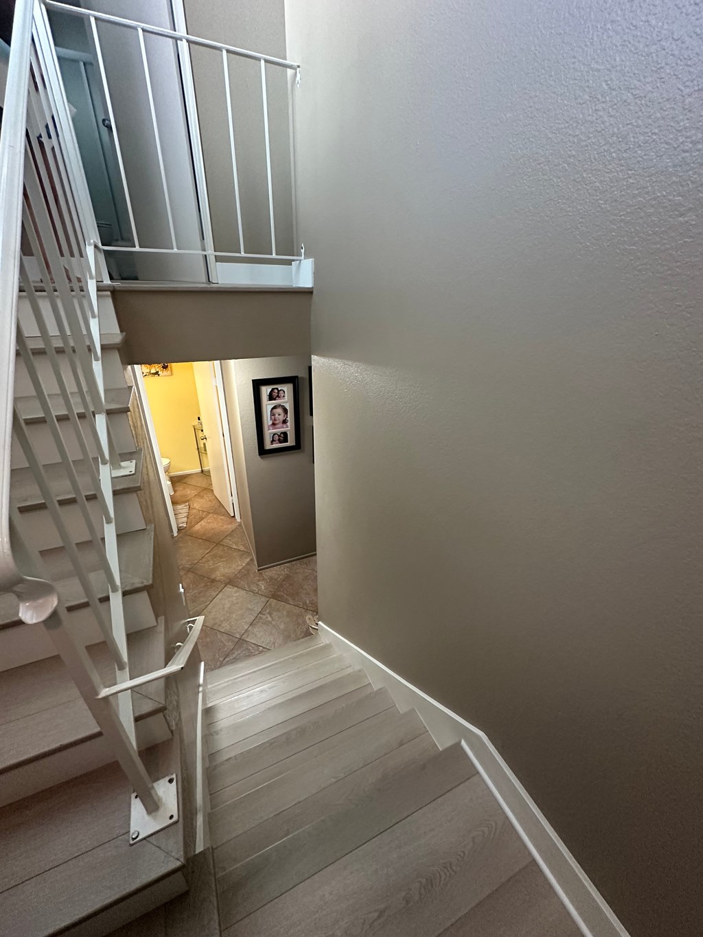 A staircase with a metal railing and wooden steps.