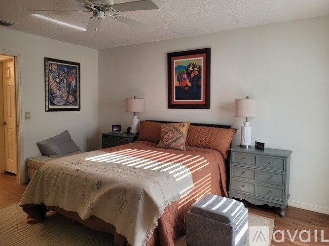 A bedroom with a bed, dresser, and chair.
