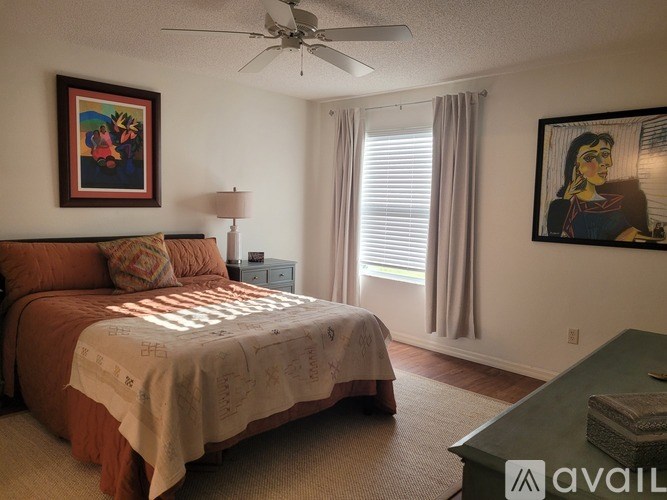 A bedroom with a bed, a dresser, and a chair.