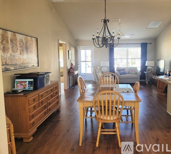 A dining room with a wooden table and chairs.