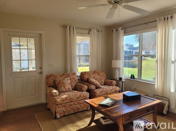 A wooden dining table with chairs and a painting on the wall.