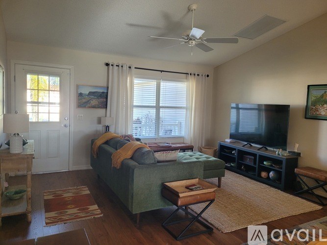 A living room with a couch, chair, and table.