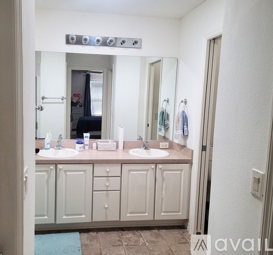 A bathroom with two sinks and a mirror above them.