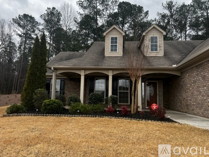 A house with a front yard and a tree.