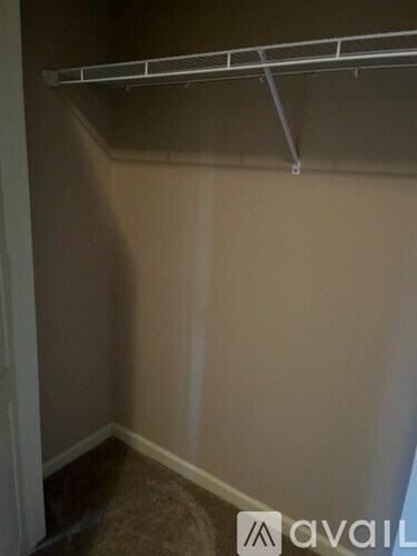 Empty room with a white wall and a white shelf.