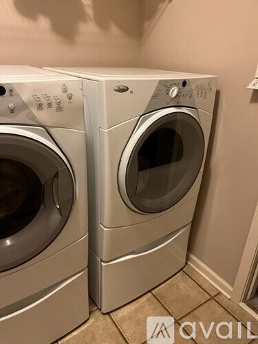 Two front loading washing machines in a laundry room.