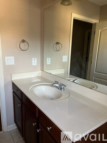 A bathroom with a sink and mirror.