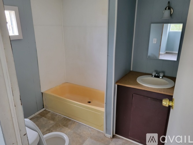 A bathroom with a tub and sink.