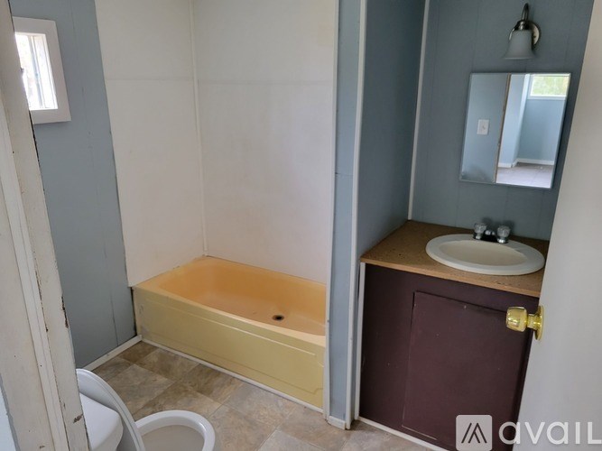 A bathroom with a tub and sink.