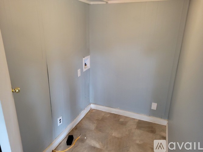 A room with a light switch and a hole in the floor.