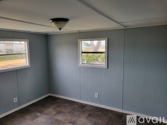 A room with a window and a ceiling light fixture.