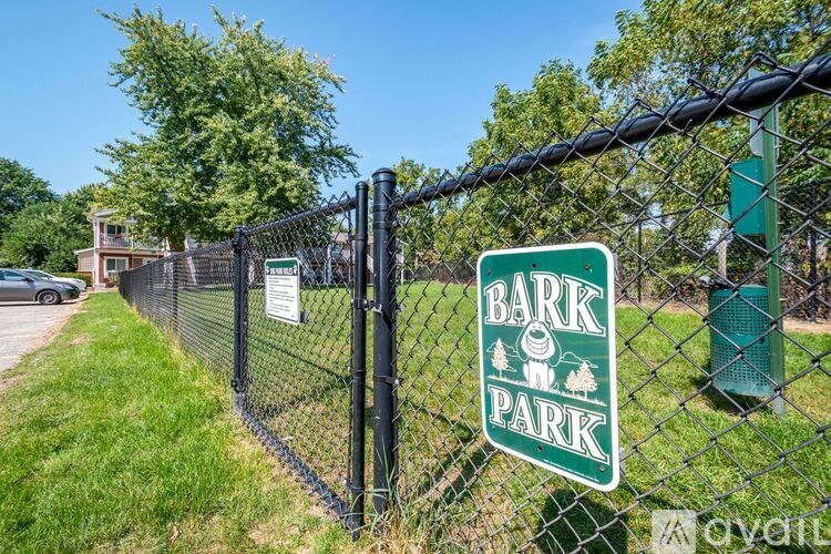 A sign for Bark Park is displayed on a fence.