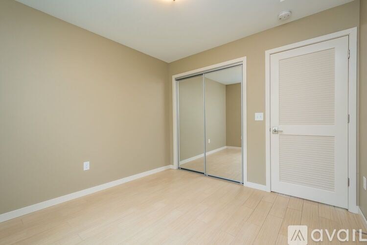 A room with a sliding glass door and a white door.