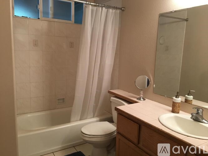 A bathroom with a toilet, sink, and bathtub.