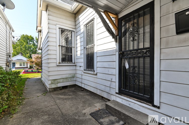 A white house with a black gate and window.