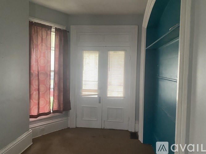 A room with a window and a door.