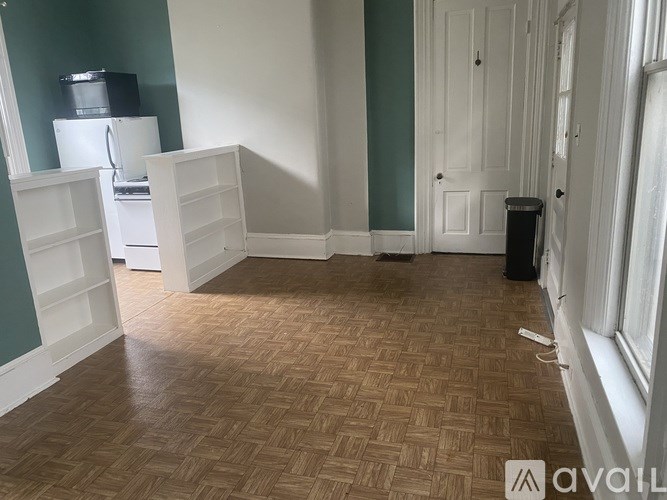 A room with a wooden floor and white walls.