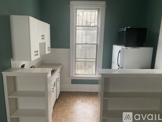 A kitchen with green walls and white appliances.