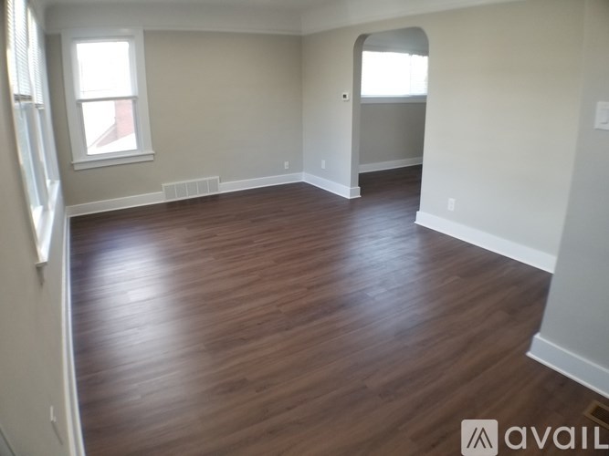 A room with wooden flooring and a window.