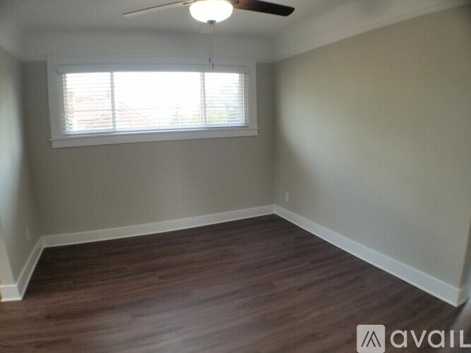 A room with a window and a ceiling fan.