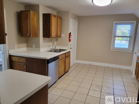 A kitchen with wooden cabinets and a white countertop.