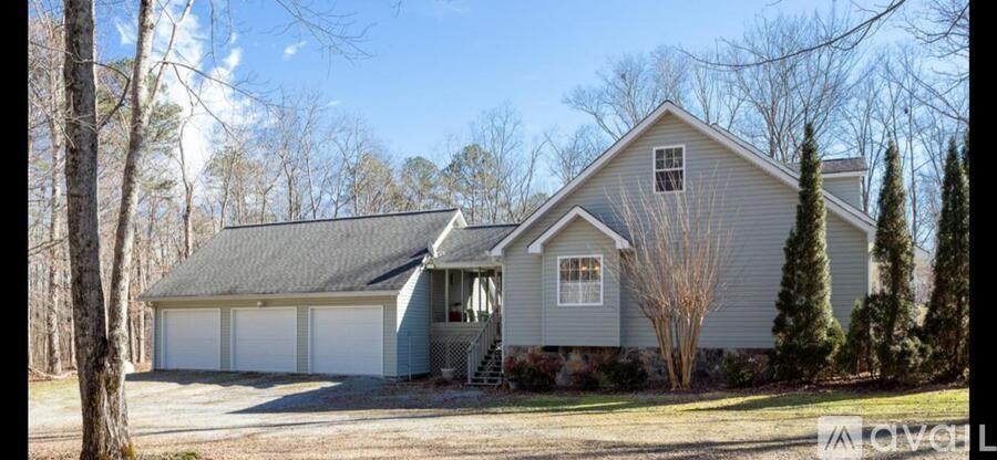 A house with a grey roof and a garage.