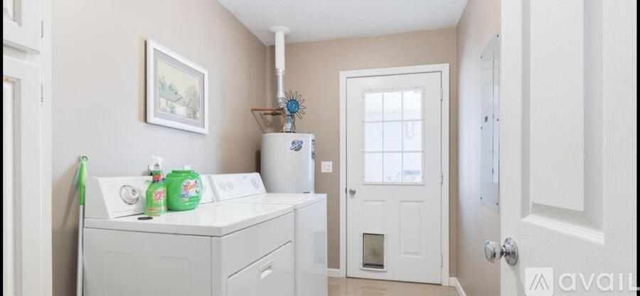 A small white laundry room with a washer and dryer.