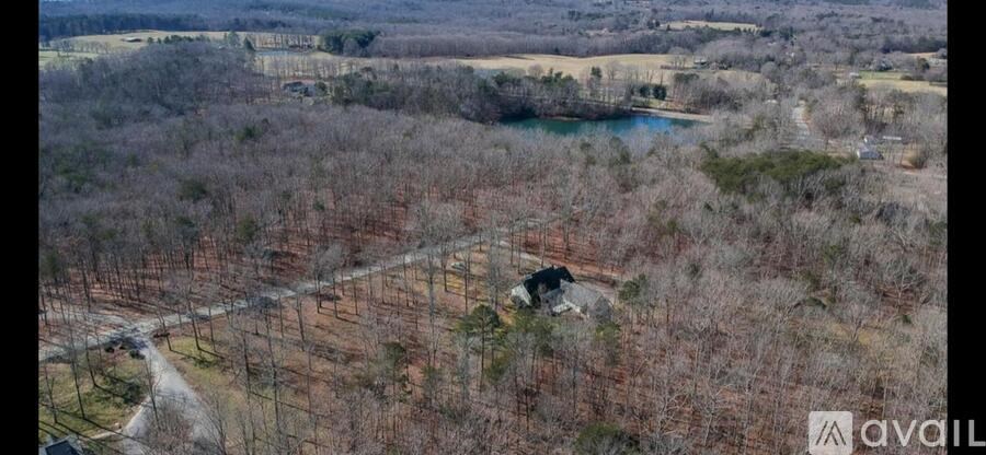 A bird's eye view of a property with a house and a lake.