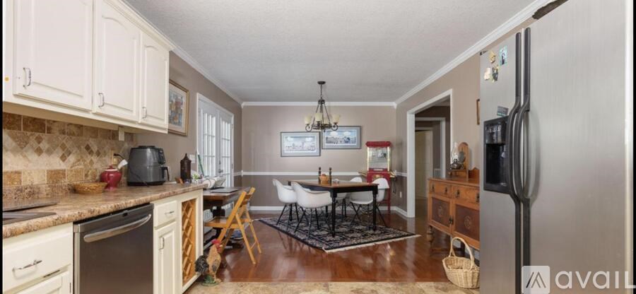 A kitchen with a refrigerator on the right side.