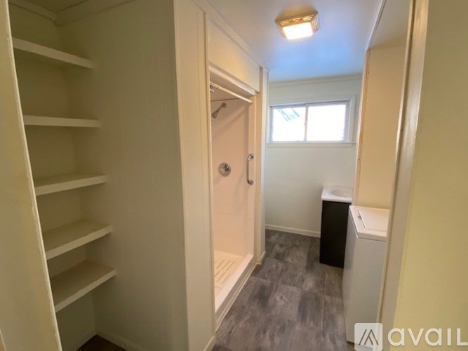 A small, empty room with a door and a window.