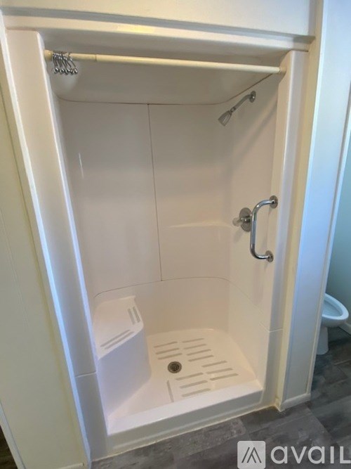 A white shower stall with a door open.