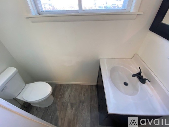 A bathroom with a toilet and sink.