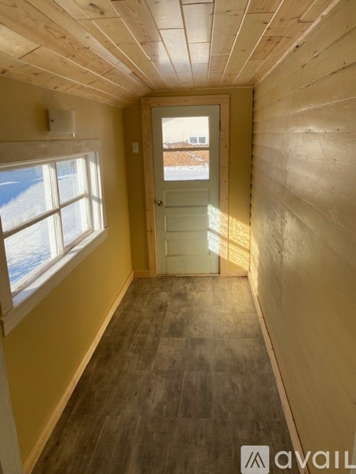 A room with a door and a window.