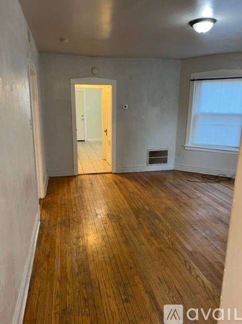 A room with wooden floors and a white door.