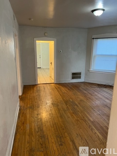 A room with wooden floors and a white door.