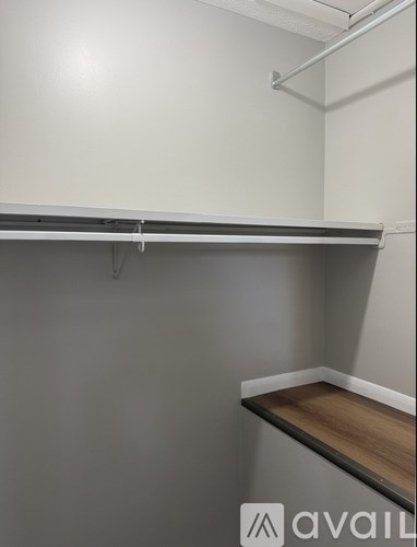 A white shelf with a wooden floor.