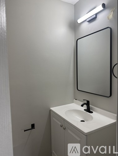 A bathroom with a sink and mirror.