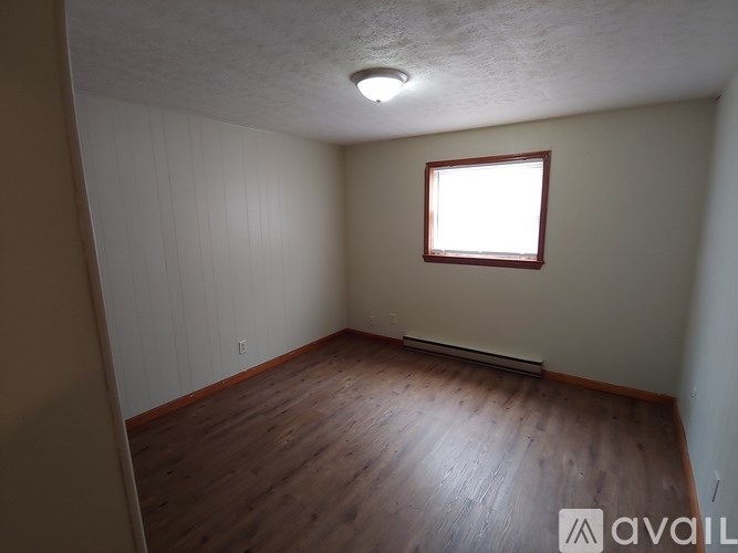 A room with wooden floors and a window.