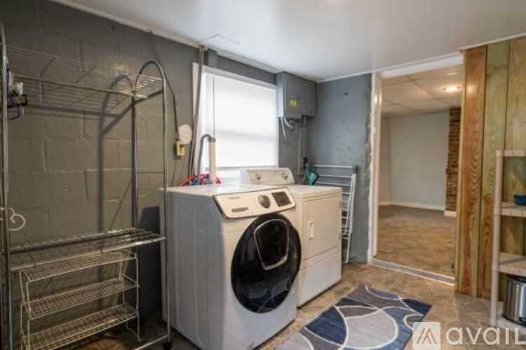A small laundry room with a washer and dryer.