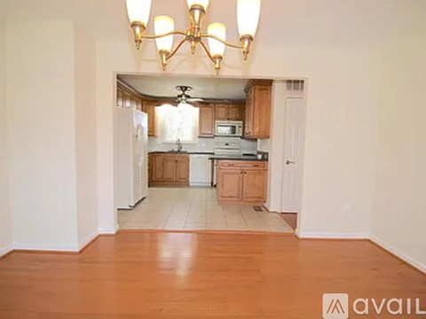 A well-lit kitchen with wooden cabinets and a central island.