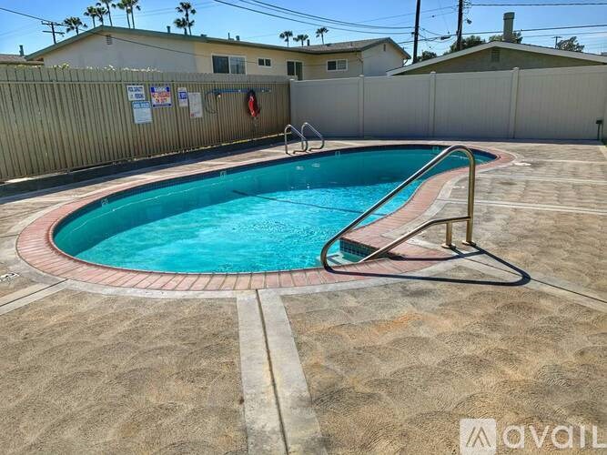 A small pool with a red and white striped pool ladder.