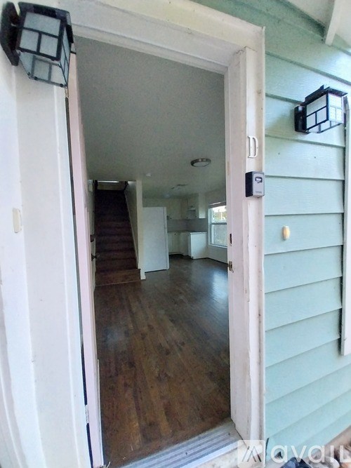 A white door is open to a hallway.