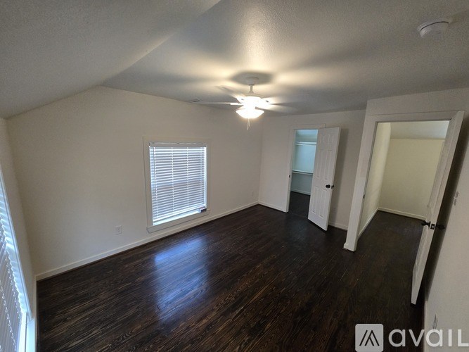 A room with wooden floors and white walls.