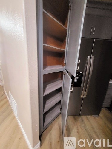 A stainless steel refrigerator with its door open.