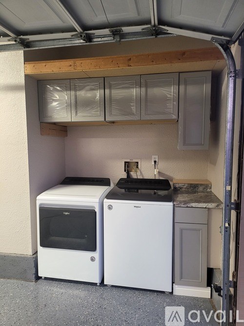 A small kitchen with a white dishwasher and microwave.