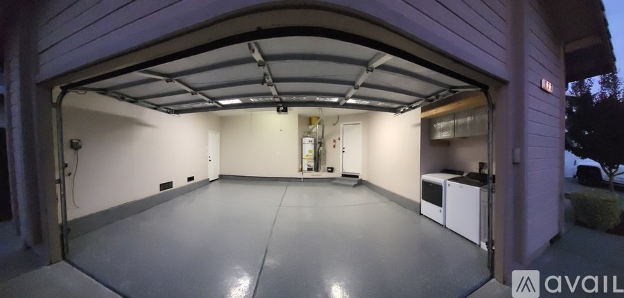 A spacious garage with a white interior and a black ceiling.
