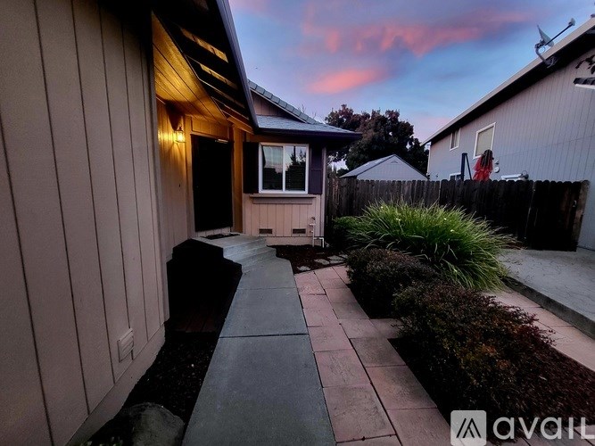A house with a wooden exterior and a small garden area.