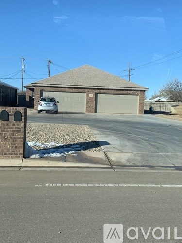 A house with a garage and a car parked in front.