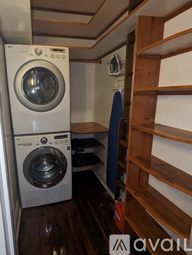 A washer and dryer stacked on top of each other in a small room.